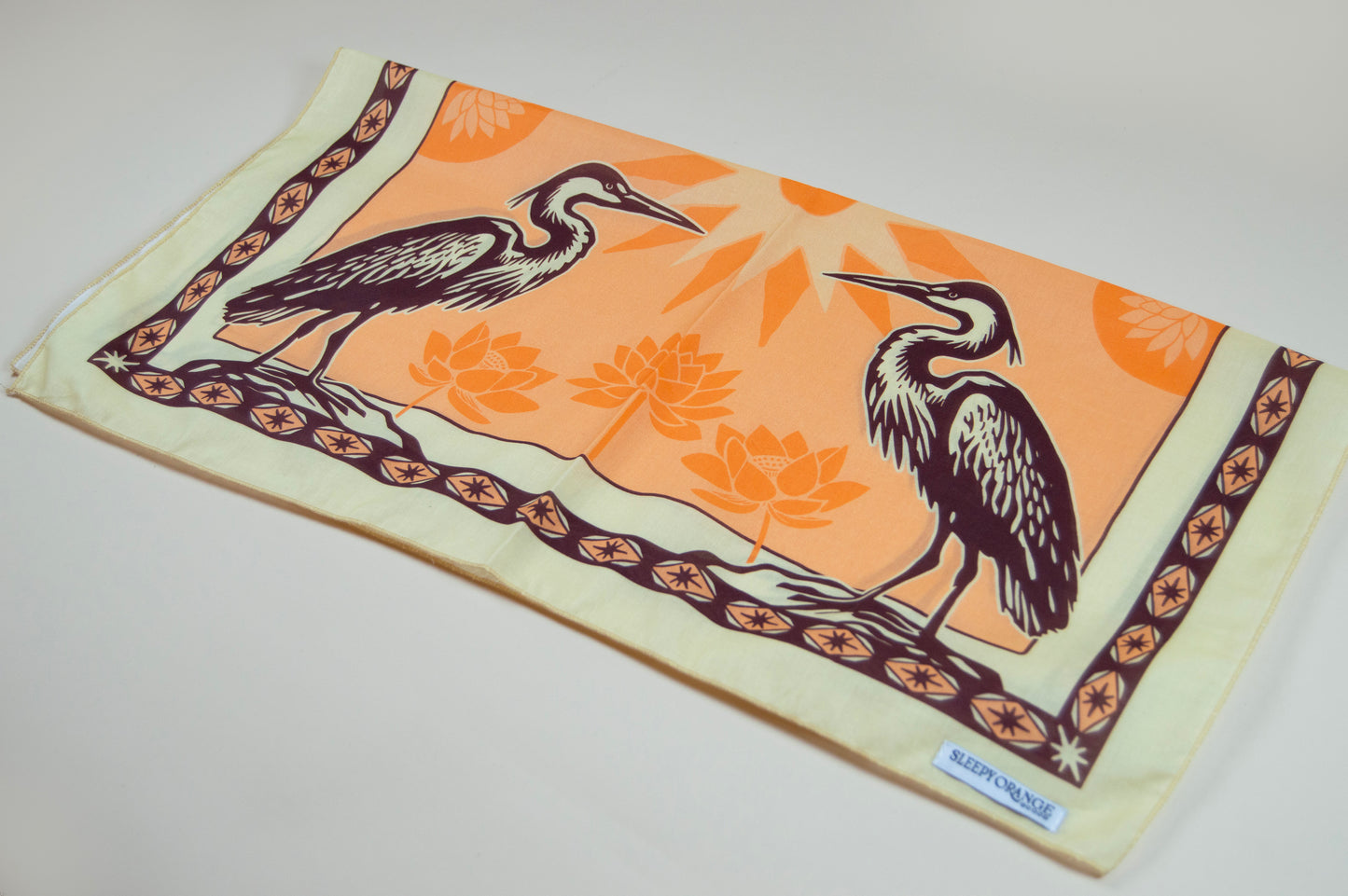 a scarf with two birds on it